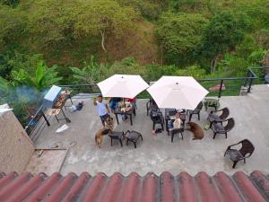 a group of people sitting under white umbrellas at Finca Pradera Real in Circasia