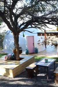 a patio with a tree and a table at Zia Geo Dome At El Mistico Ranch, Glamping in Nogal