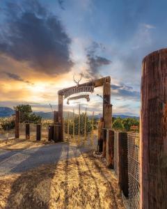 an open gate with a sign that reads attention at Zia Geo Dome At El Mistico Ranch, Glamping in Nogal