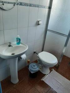 La salle de bains est pourvue d'un lavabo, de toilettes et d'une douche. dans l'établissement Casa de Temporada - São Sebastião - Praia Barequeçaba - 500m da praia, à São Sebastião