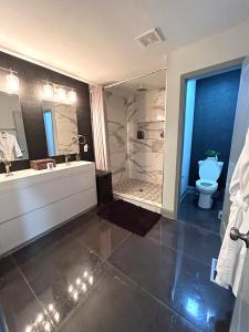 a bathroom with a tub and a sink and a toilet at Stylish, Fully Furnished Home in Dwtn Atlanta in Atlanta