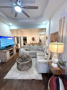 a living room with a couch and a tv at Stylish, Fully Furnished Home in Dwtn Atlanta in Atlanta