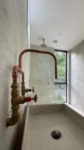a kitchen sink with a copper water faucet at Tranquil Conservation RETREAT in Matata