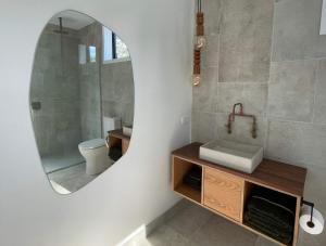 a bathroom with a sink and a mirror at Tranquil Conservation RETREAT in Matata