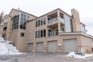 a large house with two garages in front of it at The Lofts #9d - Ski-inout With Private Hot Tub in Brian Head