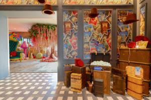 a room filled with lots of boxes and a colorful wall at Wonka Sweet Suite - New York in New York