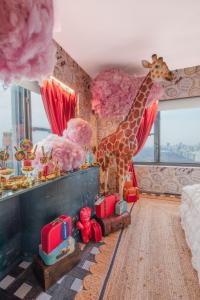 a room with a giraffe and toys in it at Wonka Sweet Suite - New York in New York