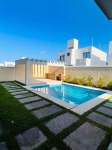 a swimming pool in front of a house at Torre Riviera el mar in Guadalupe