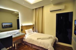 a hotel room with a bed and a desk at MIO BOUTIQUE Hotel in Malacca