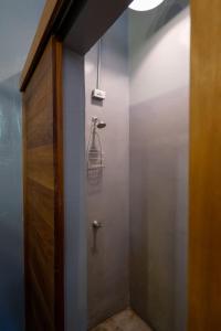 a bathroom with a door and a lamp on the wall at Casa Tunido in Santa Marta