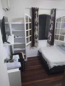 a bedroom with a bed and a television in it at Pousada Kundalini Arraial in Arraial do Cabo +56 photos