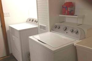 a white laundry room with a washer and dryer at Panoramic Mountain views w/hot tub, hiking trail in Fairlee