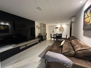 a large living room with a couch and a television at Apartamento - Resort Golf Ville in Aquiraz