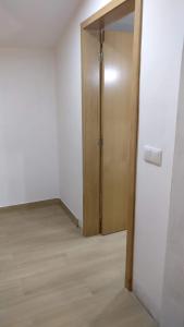 a door in an empty room with a wooden door at Areias Village in Vale de Cambra