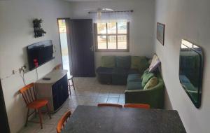 ein Wohnzimmer mit einem Sofa und einem Tisch in der Unterkunft Casa de praia in Itapoa