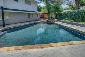 a swimming pool in front of a house at Entire Cozy Getaway with Pool in Norman