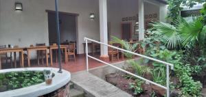 a house with a staircase and a table and chairs at Hotel Casa Barcelona in Granada