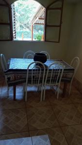 a dining room table with chairs and a bowl on it at Sítio Recanto das Pedras /Boca da Mata Ijaci in Ijaci