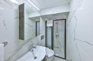 a bathroom with a sink and a shower at AGACH Apart 1 & 2 in Milas