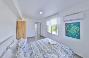 a bedroom with a bed and a painting on the wall at AGACH Apart 1 & 2 in Milas