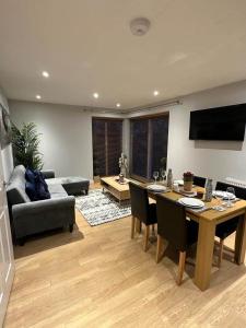 a living room with a table and a couch at Contemporary, Stylish Apartment in Weston in Worle