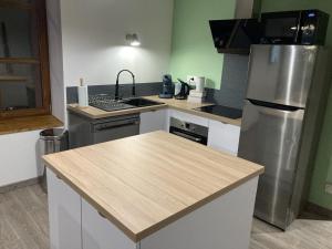 a kitchen with a sink and a refrigerator at L'éscale étape in Lagney