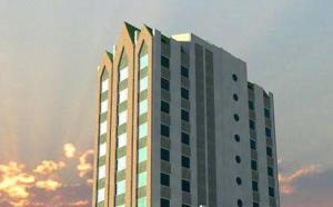 a tall white building with the sky in the background at Hotel Aranjuez in Chillán