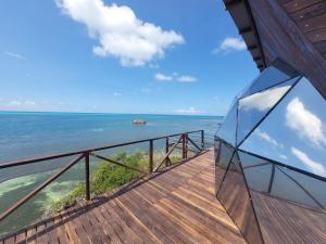 a balcony with a view of the ocean at 321 Surprise Beach house and Glamping in Providencia