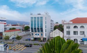 a city street with a large white building at Hotel 19, Penang in George Town