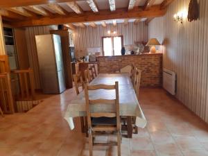 a kitchen and dining room with a table and chairs at Gîte Mauzens-et-Miremont, 6 pièces, 10 personnes - FR-1-616-254 in Mauzens-et-Miremont