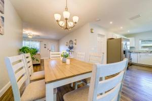 a dining room and kitchen with a wooden table and chairs at Palm Lagoon Clearwater - 3 bedroom Resort House with heated pool & SPA in Clearwater