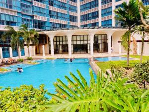 a swimming pool in a building with people in it at Luxury 2BR with Balcony Suite 8 - City View in Manila