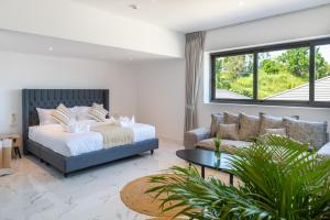 a bedroom with a bed and a couch at Luxury 5 bedroom oceanview villa in Bophut with Staff in Amphoe Koh Samui +39 photos