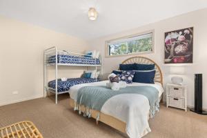 Voodi või voodid majutusasutuse White Sands Deck House by Experience Jervis Bay toas