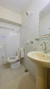 a bathroom with a toilet and a sink at Hotel Royal Blue Residence in Dhaka