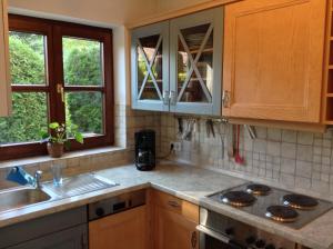 a kitchen with wooden cabinets and a stove top oven at Am Park in Garmisch-Partenkirchen