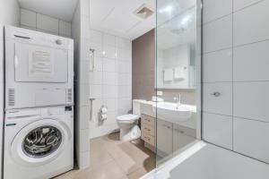 a bathroom with a washing machine and a sink at Hudson Parap in Darwin