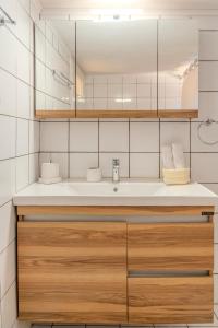 a bathroom with a sink and a mirror at Georgina's Meteora Loft Apartment in Kalabaka