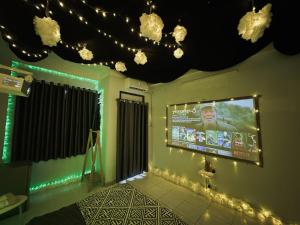 a room with a large screen on the wall with lights at LOPO homestay Ba Tháng Hai in Ho Chi Minh City