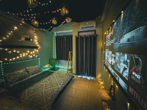a bedroom with a bed with lights on the wall at LOPO homestay Ba Tháng Hai in Ho Chi Minh City