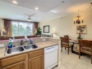 a kitchen with a sink and a dining room at Disney just 1 and a quarter mile away, Blue Heron 1 room 2 bath,amenities,6 guests, walk to restaurants in Orlando