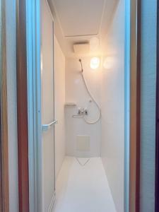a bathroom with a shower and a toilet at ReA house 心斎橋.島之内 in Osaka