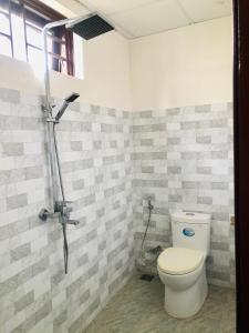 a bathroom with a toilet and a shower at Phuong Trang Villa Hoi An in Hoi An