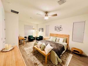 a bedroom with a large bed and a living room at Palm Coast Paradise : Cozy 3BR Vacation Retreat in Palm Coast