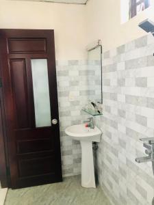 a bathroom with a sink and a mirror at Phuong Trang Villa Hoi An in Hoi An