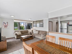 a living room with a couch and a table at Yarrawonga Lakeside Apartment 41 in Mulwala