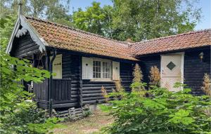 an old log cabin with a red roof at 2 Bedroom Beautiful Home In Hr in Höör