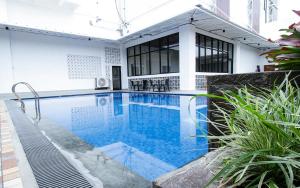 a swimming pool in the middle of a house at Sepanak Hotel by Amazing in Curup