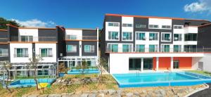 a building with a swimming pool in front of it at The Sky Pool Villa in Suncheon
