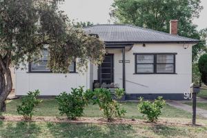 a white house with a tree in front of it at Live in the Heart of Mudgee at Fairbairn Cottage in Mudgee